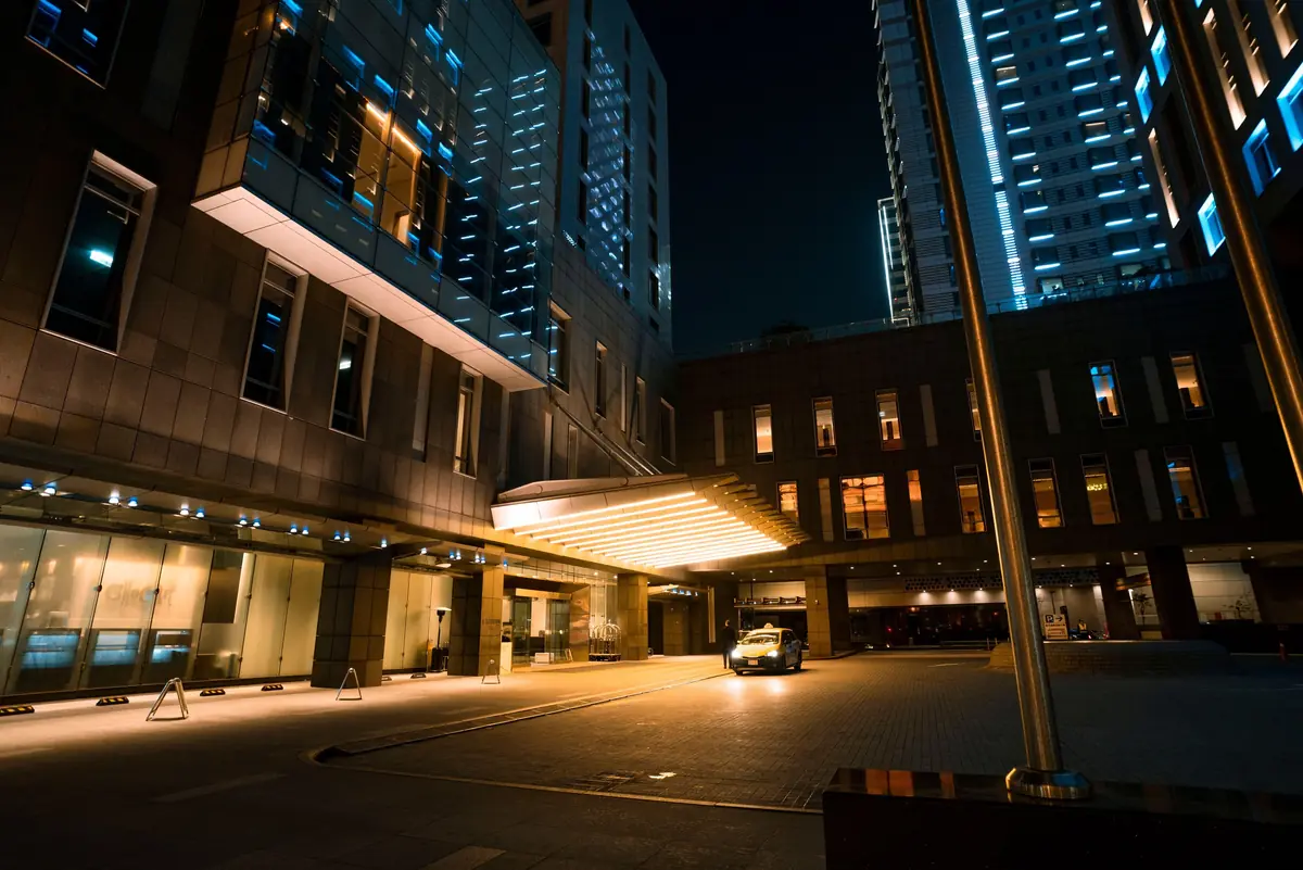 A hotel entrance lit at night