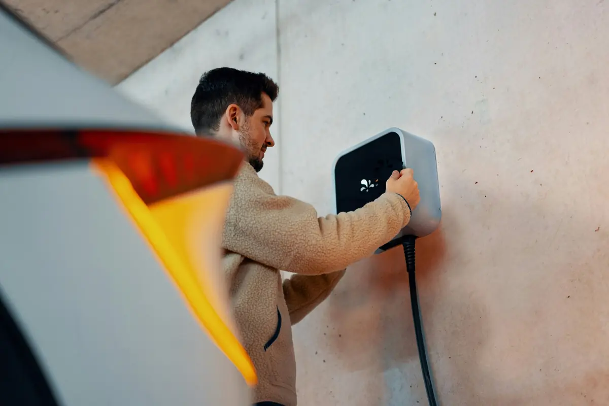 An electrician mounts a wall charger