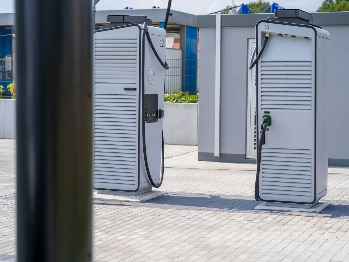 Two DC fast chargers on a paved charging site