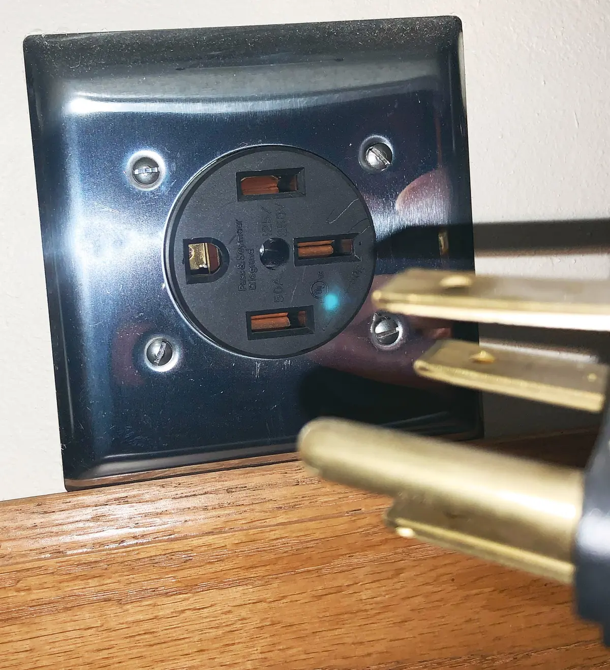 A 240-volt outlet with a plug going in