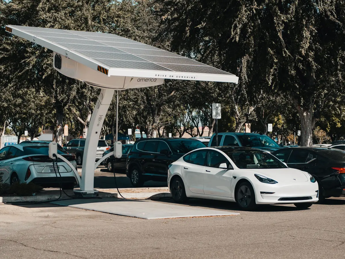 Cars charging under a solar canopy in a car park