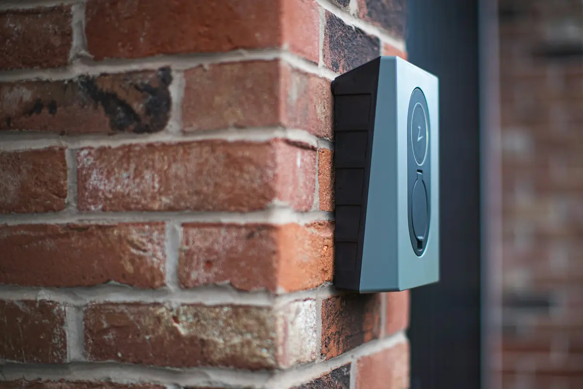 A wall charger mounted on a brick wall